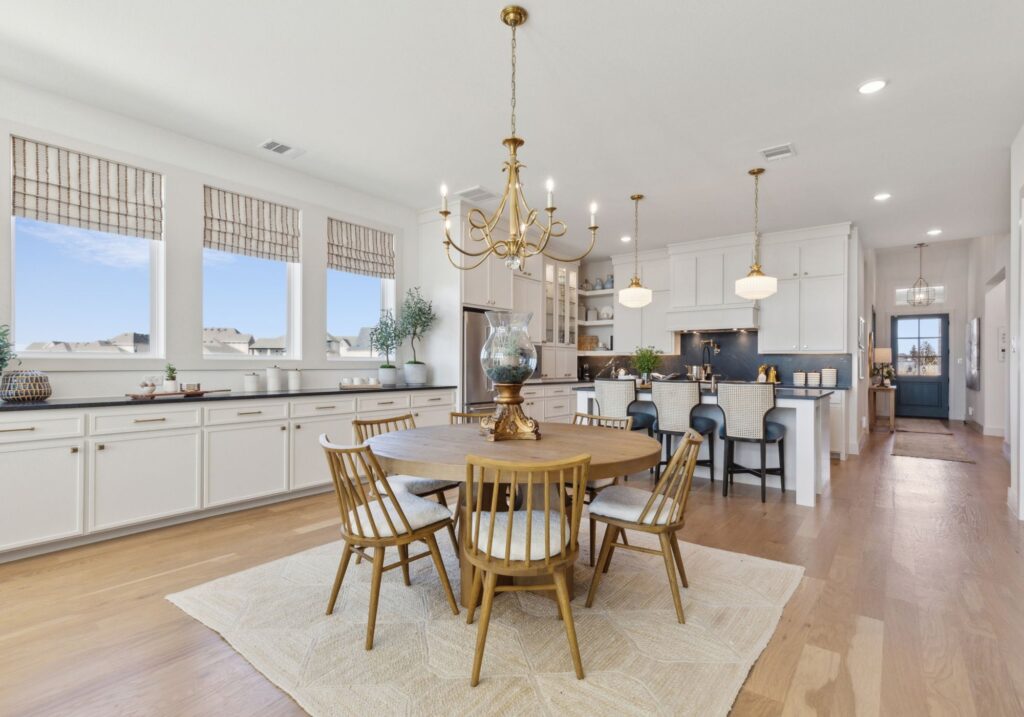 Dining area and kitchen in the Lakewood III Floorplan at Painted Tree 50' Series.